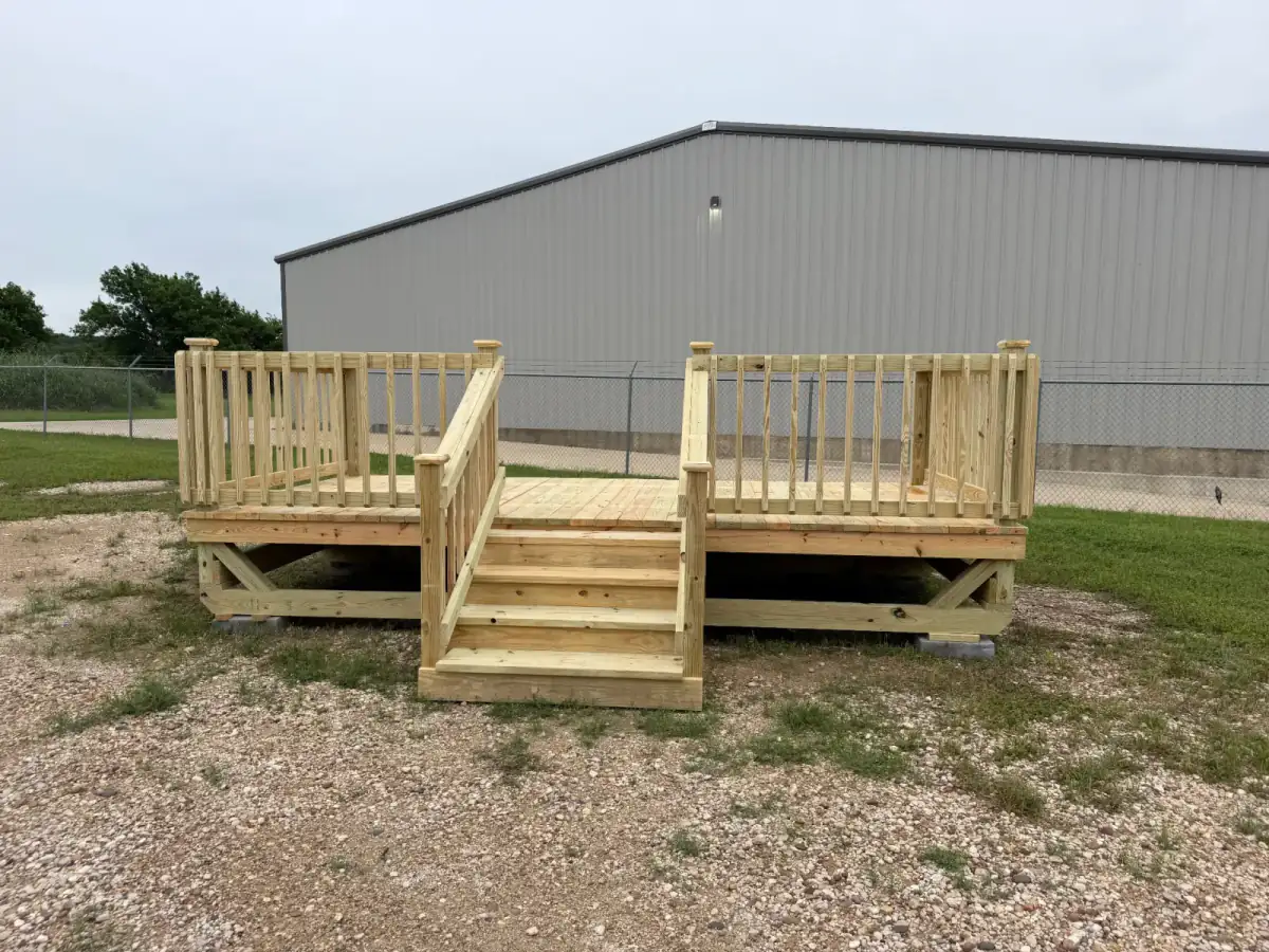 Custom pine deck overlooking pond with railing built by BenchMark Decks in Texas