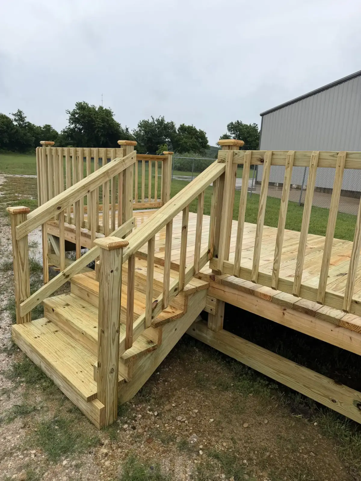 Custom pine deck with railing built by BenchMark Decks