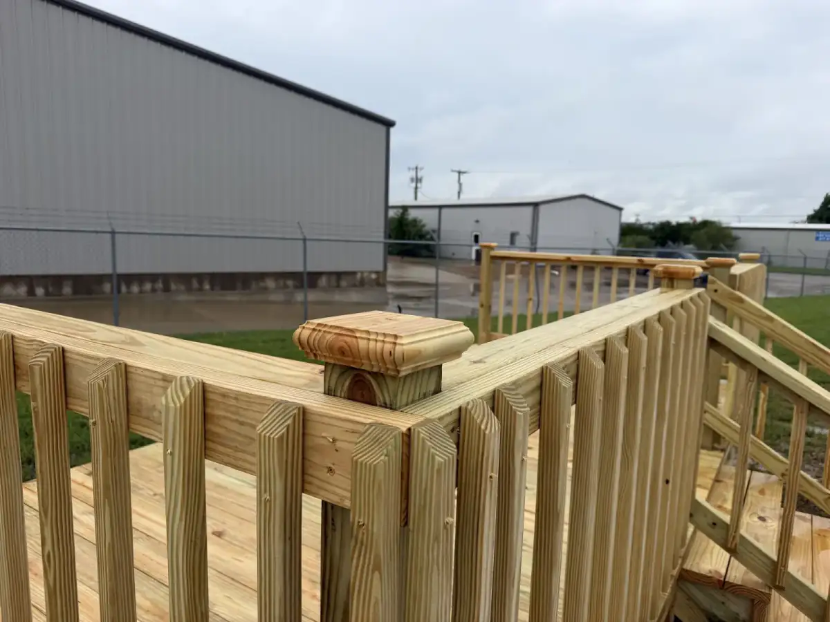 Close-up of decorative post cap on pine deck railing